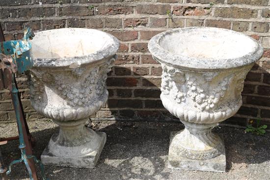 A pair of moulded reconstituted garden urns